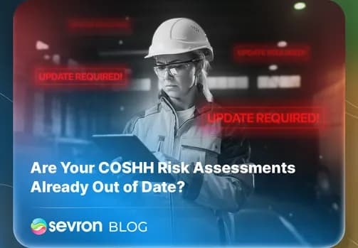 A safety manager in a hard hat reviews a tablet showing UPDATE REQUIRED alerts, emphasizing the importance of keeping COSHH assessments current